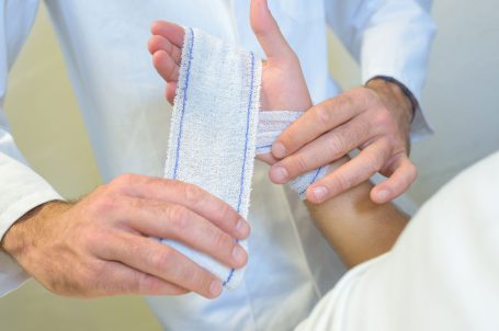 An image of a Doctor attending to a minor hand injury